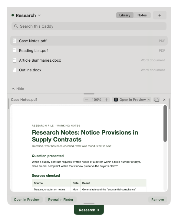 A Caddy named Research hanging from the top edge of a display, open, with a Library of four files above a reading pane.